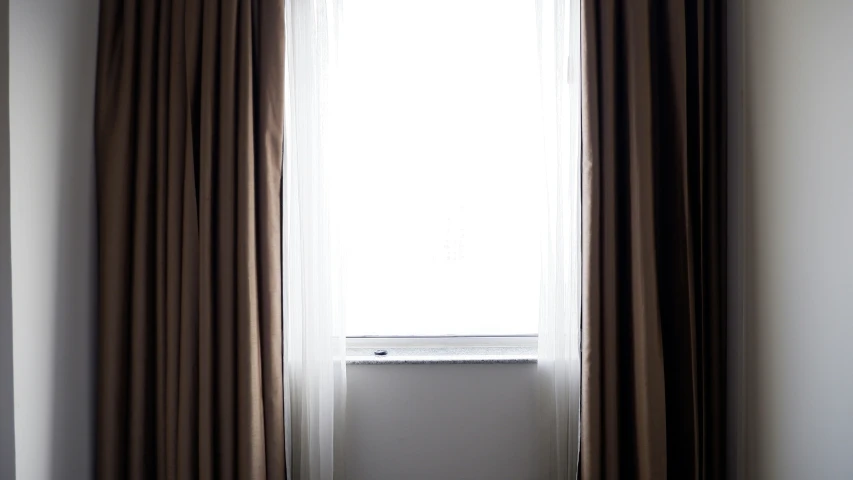 a room with a window and two small blinds