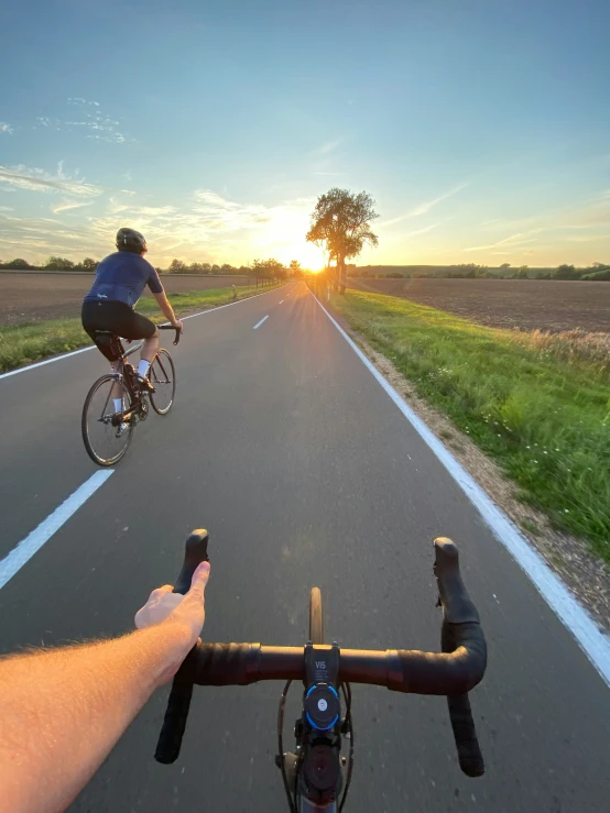 a man rides his bike down the middle of a road