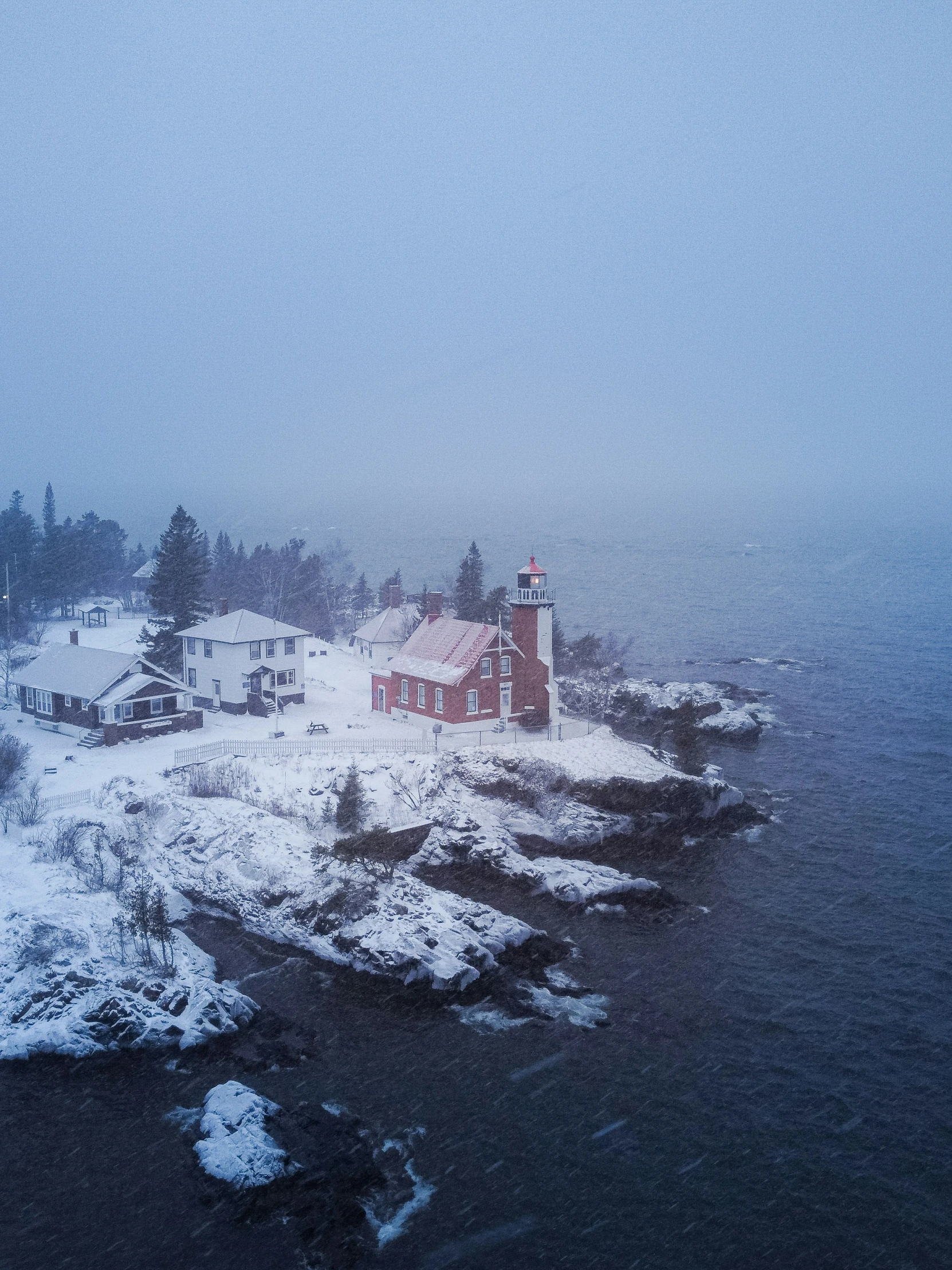 an aerial view of an island with snow on the ground