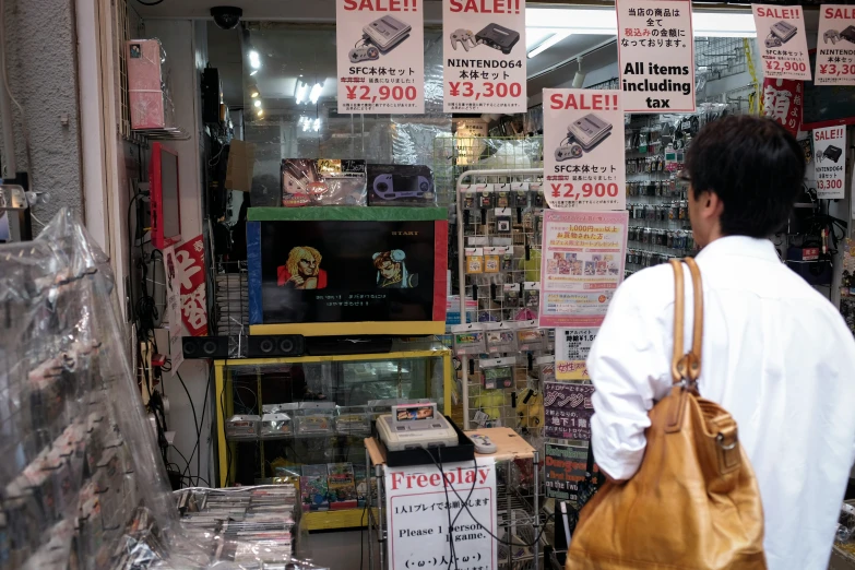 a man standing next to a pile of cds