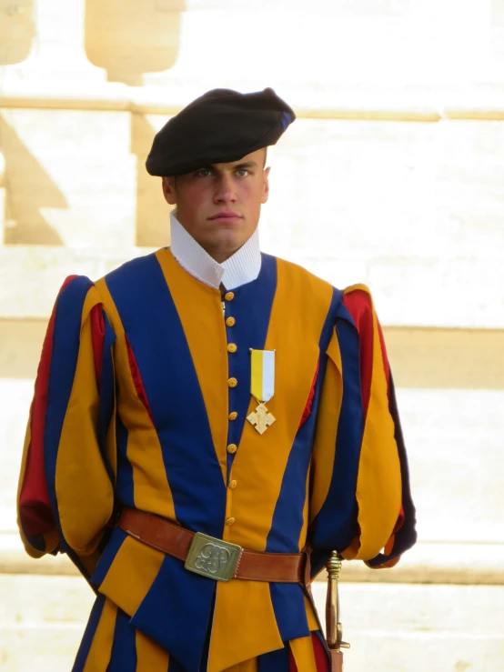 man in traditional colorful military uniform standing on street