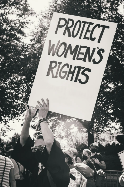 a protestors holds up a sign during the women's march