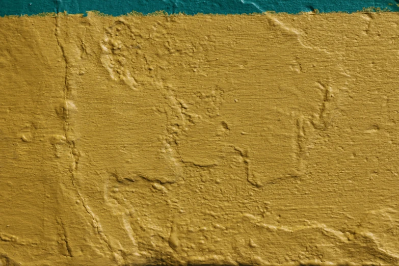 a piece of yellow and green painted wall