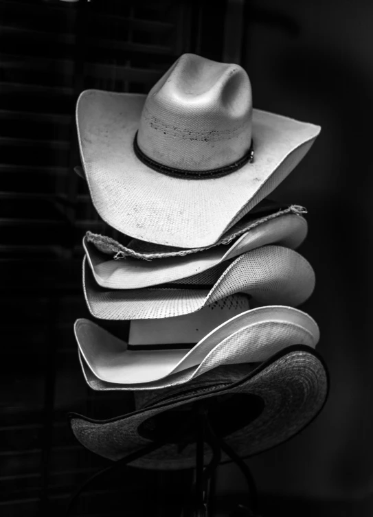 a pile of hats are stacked on top of each other