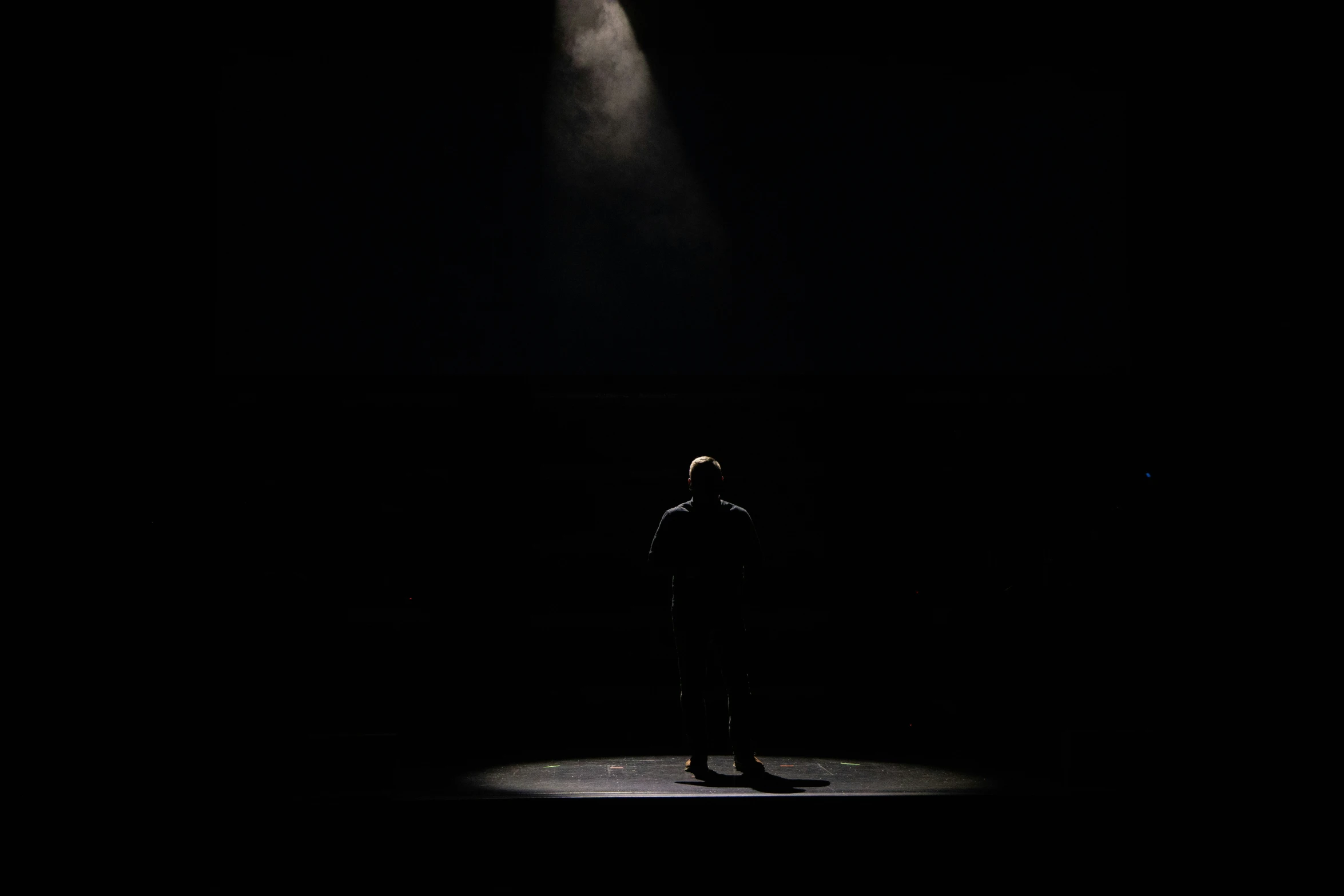 a person standing on a stage with a light on