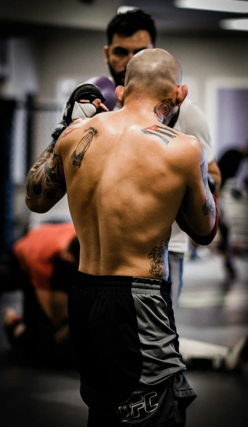 a man in a gym holding an object