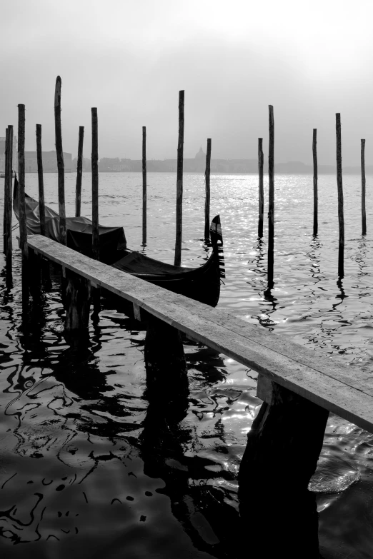 black and white pograph of a dock near water