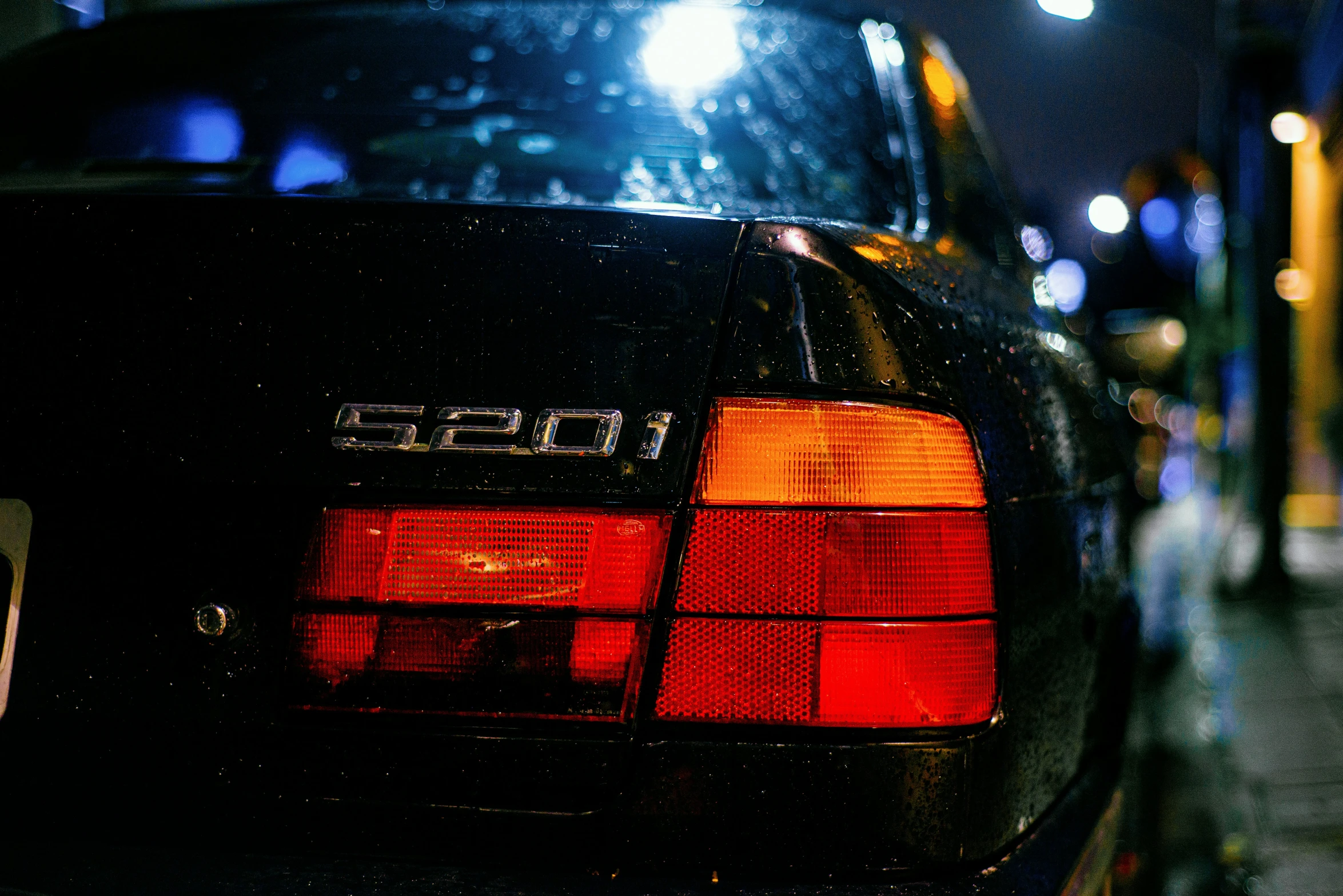 the back end of a car parked at night