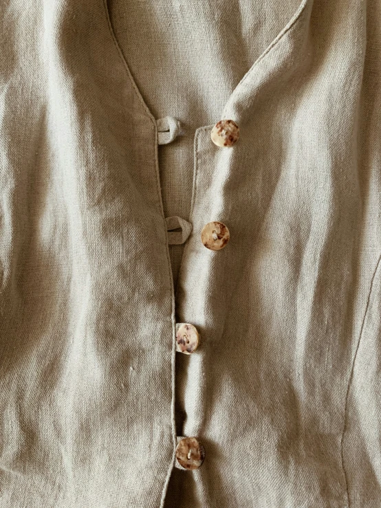 a white sweater with a bunch of ons is shown