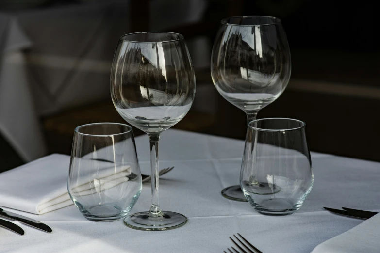 a close up of three empty wine glasses