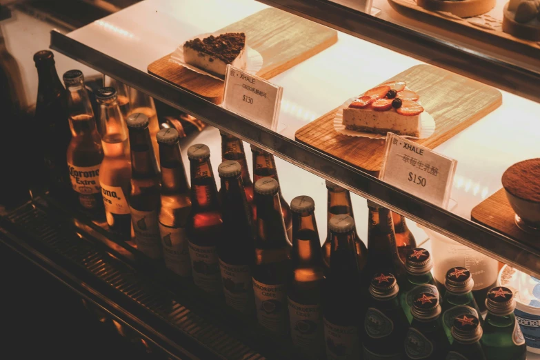 a glass case containing cakes and other beverages