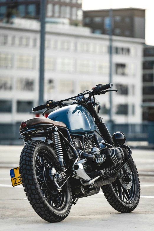 a motorcycle parked next to some tall buildings