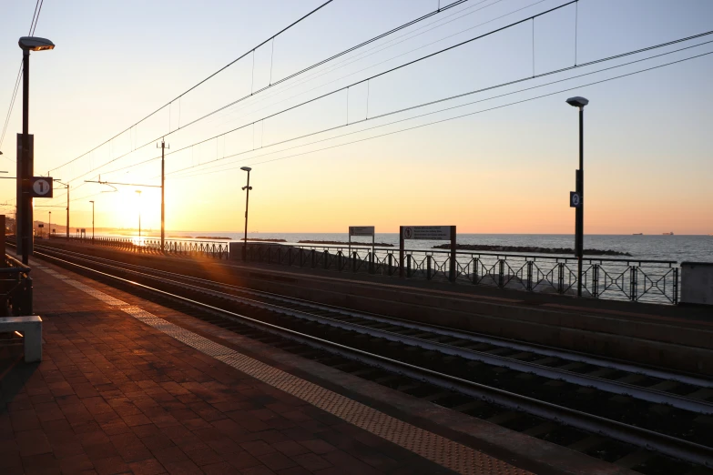 a train track that is next to a body of water