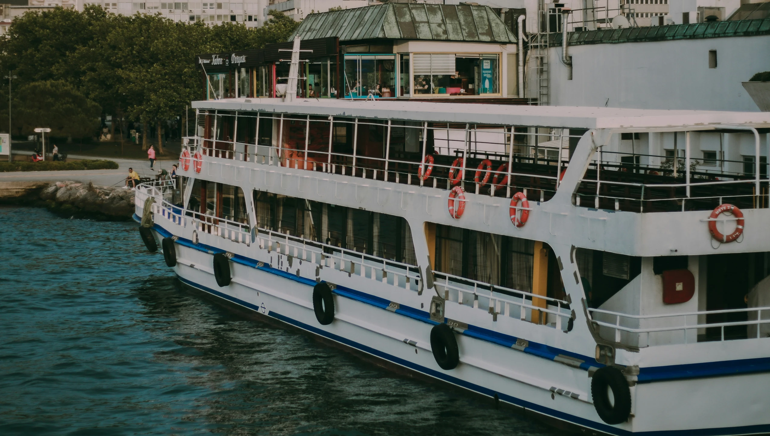 this is a small white boat sitting on the water