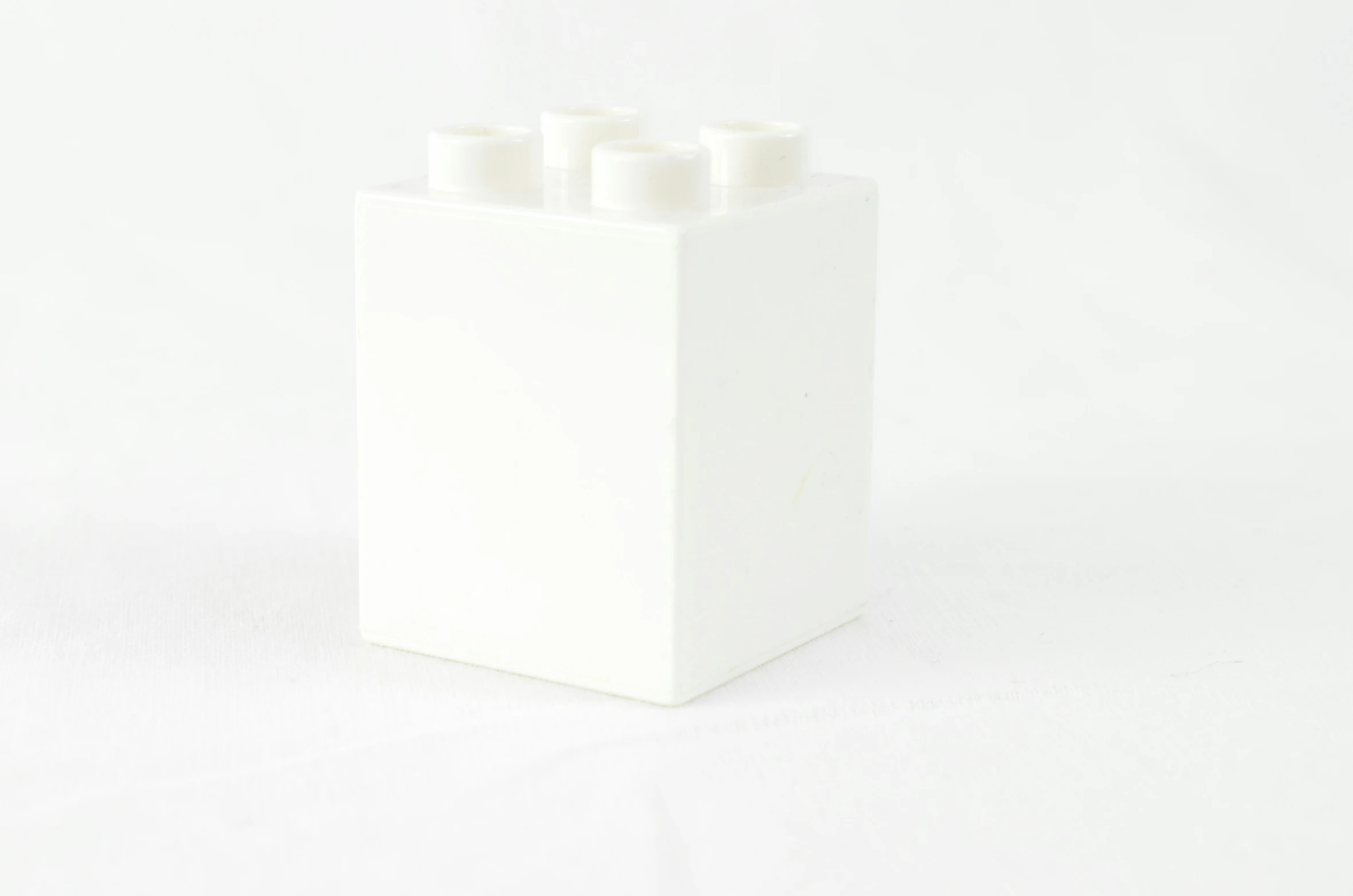 several white candles in a square box