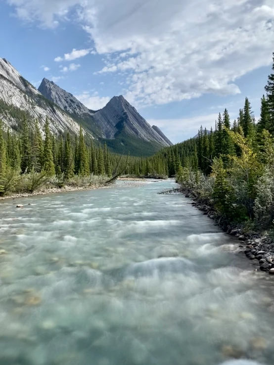 a po taken from the ground of a mountain river with clear water