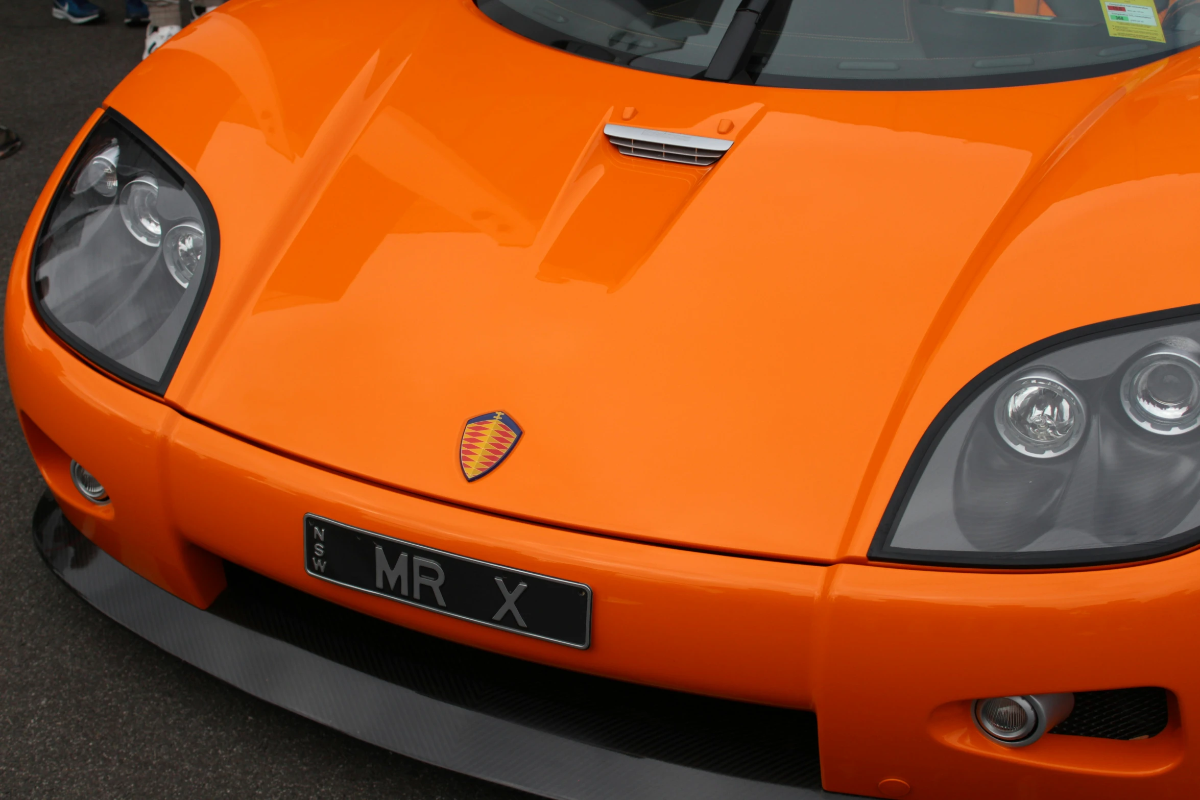 a close up of a sports car on the street