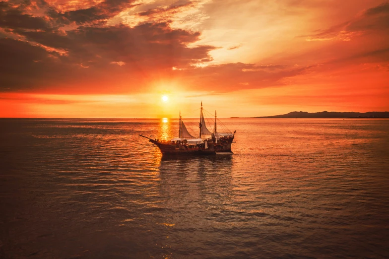 a boat is floating on the water during a sunset