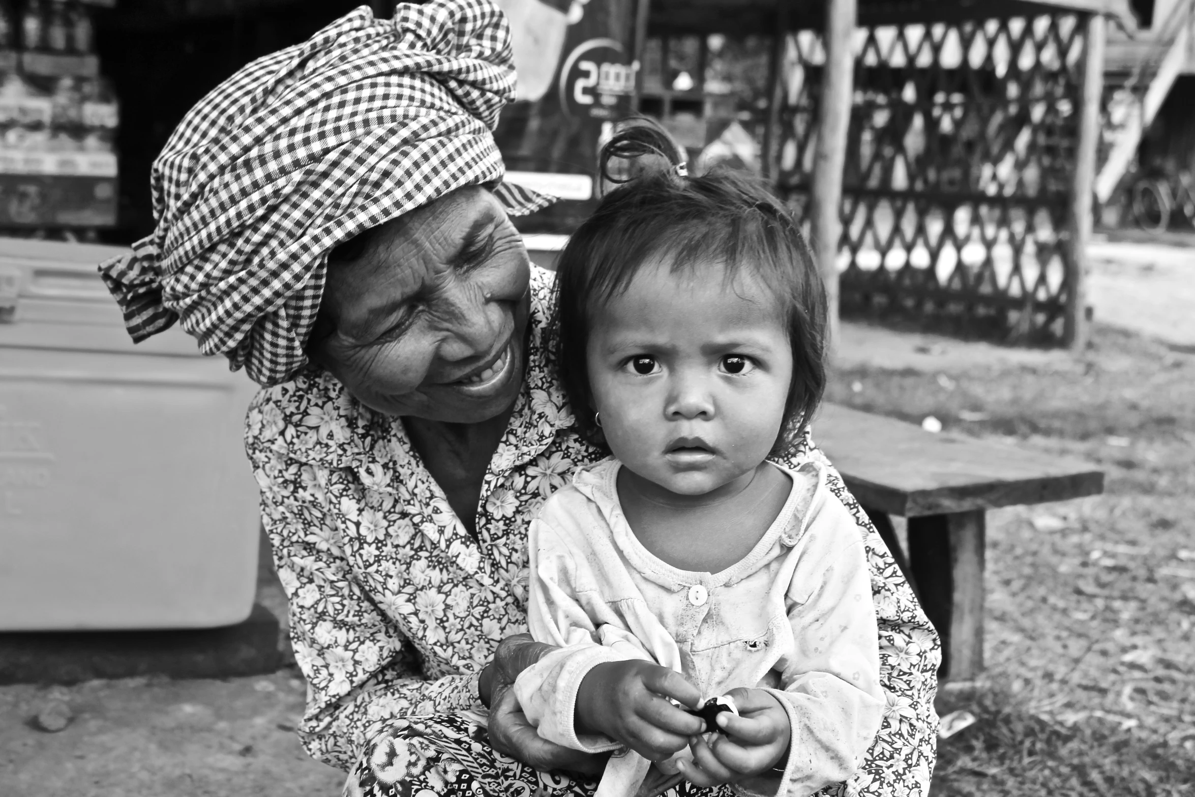 a women is carrying her daughter on her back