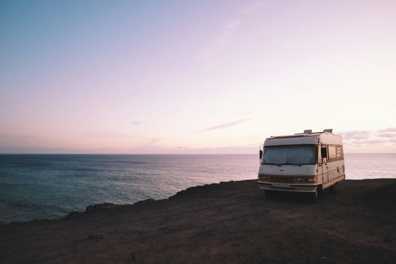 an rv is parked on a rocky outcropping