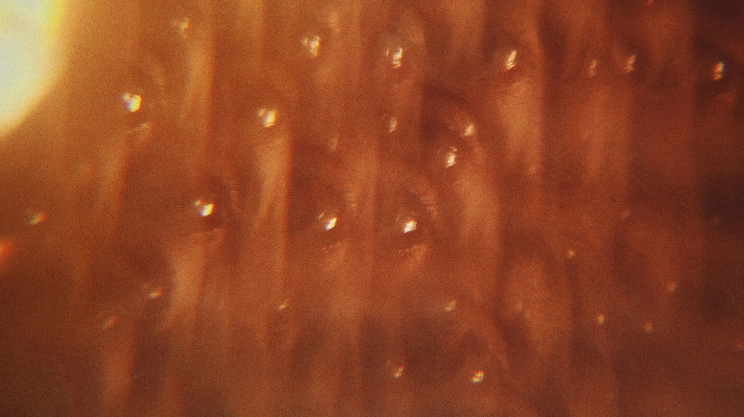 water drops on the brown surface of a mirror