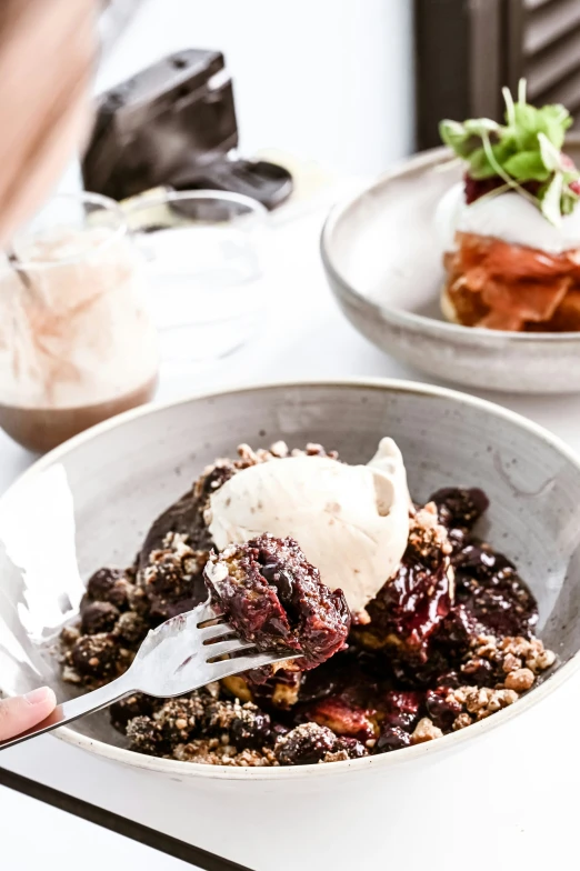 a bowl full of berries, ice cream and fruit