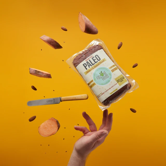a hand throwing up some kind of chopped food into the air