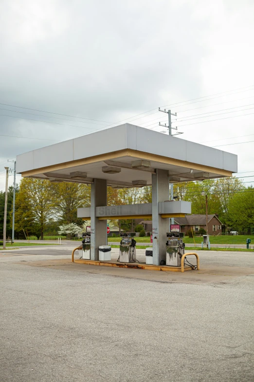 a gas station with several people sitting at the gas pumps