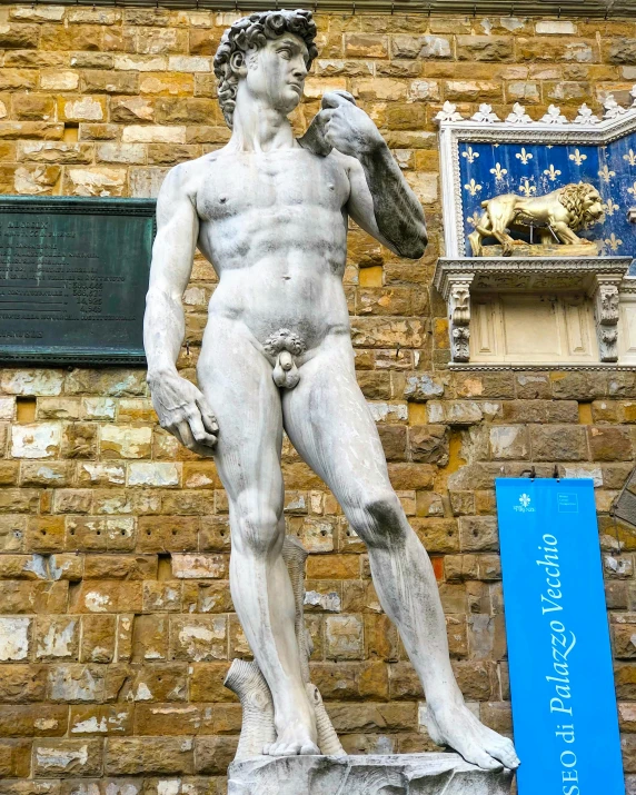 a statue of a man holding a bird and a clock