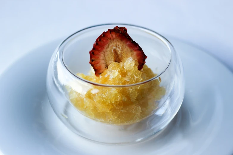 a small bowl of sugar and fruit on a table