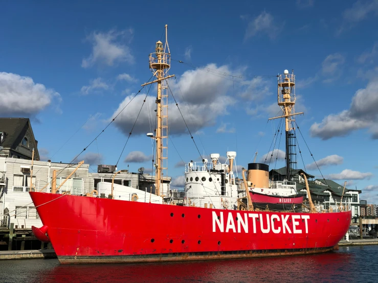 the large red and white boat is docked