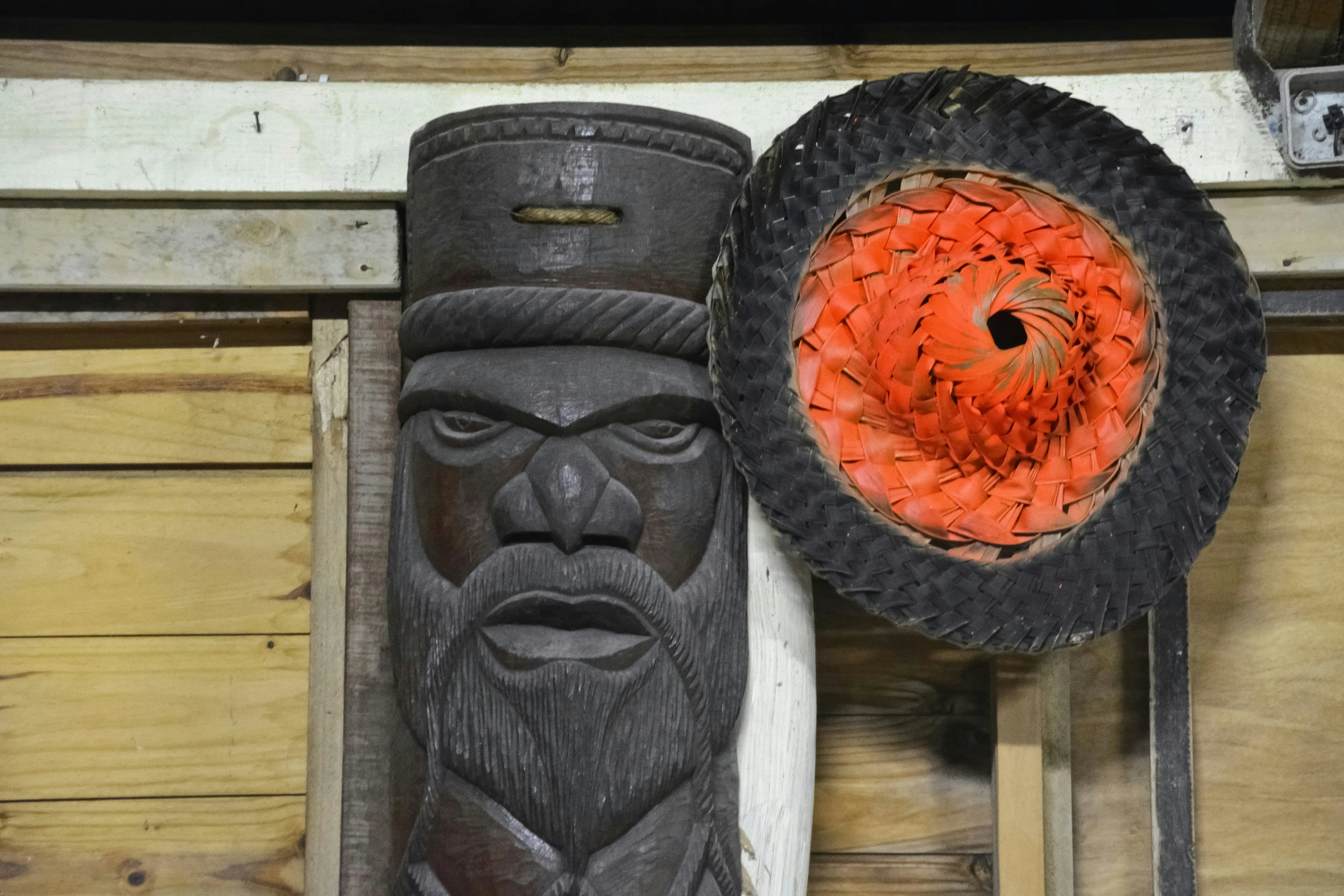 a close - up of a decorative item and a black object on the wall