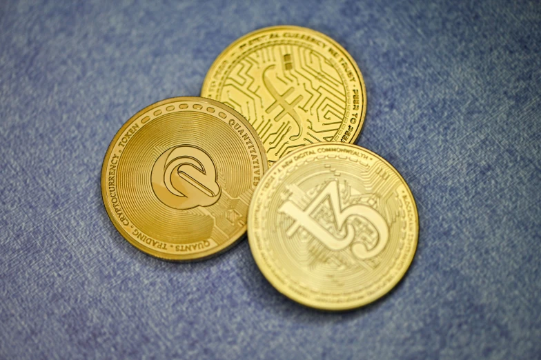 gold bitcoins laid out on blue background
