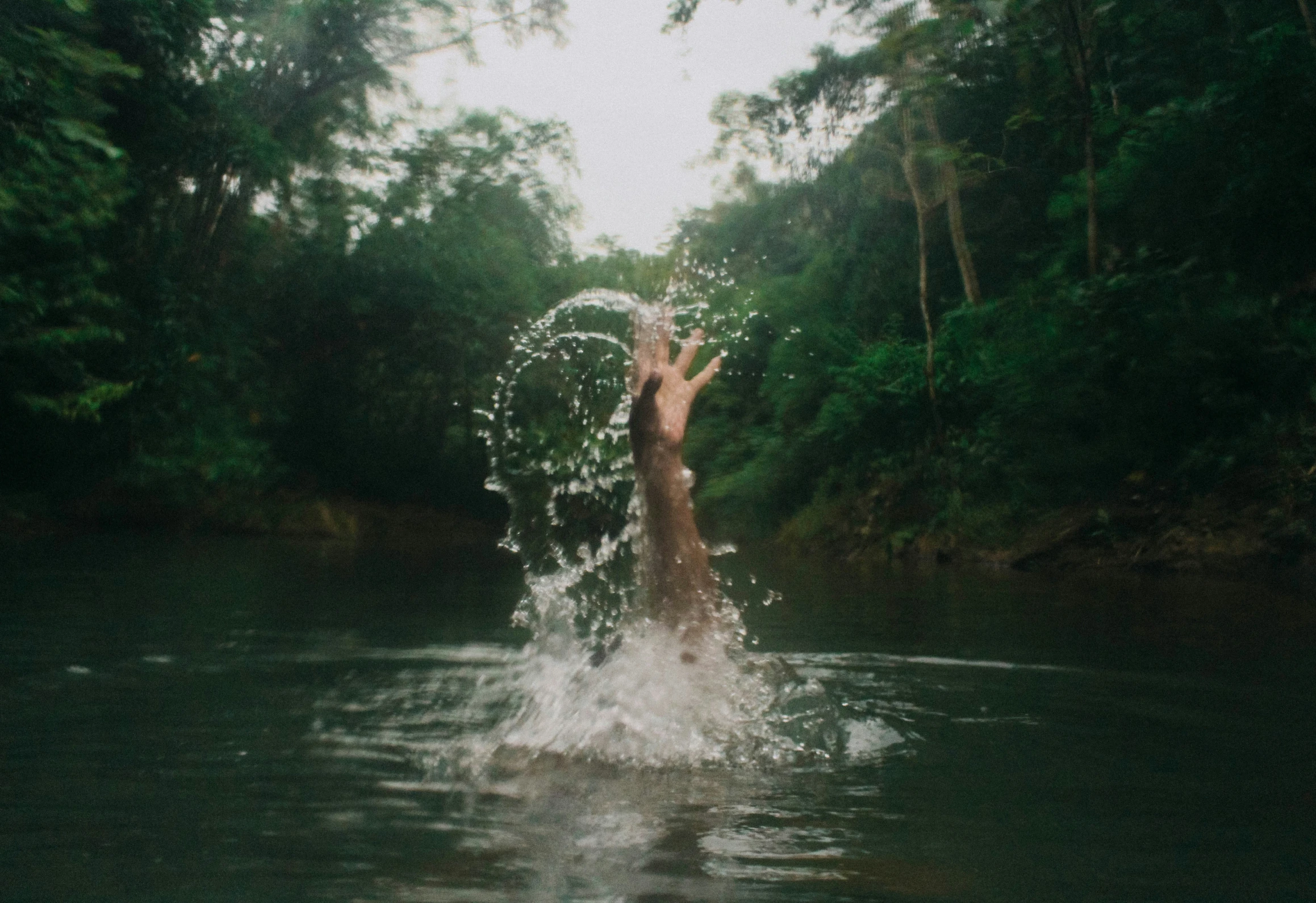 a person jumping into a body of water