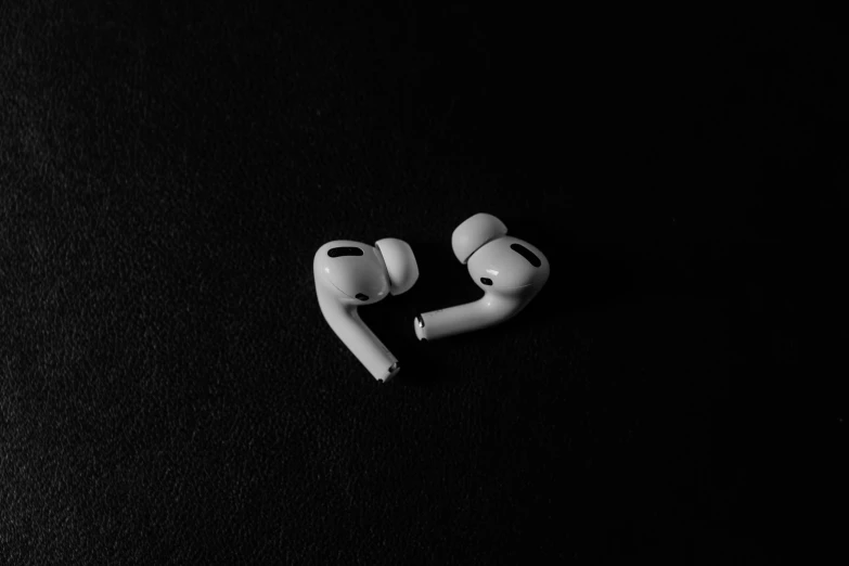 two earphones laying side by side on a surface