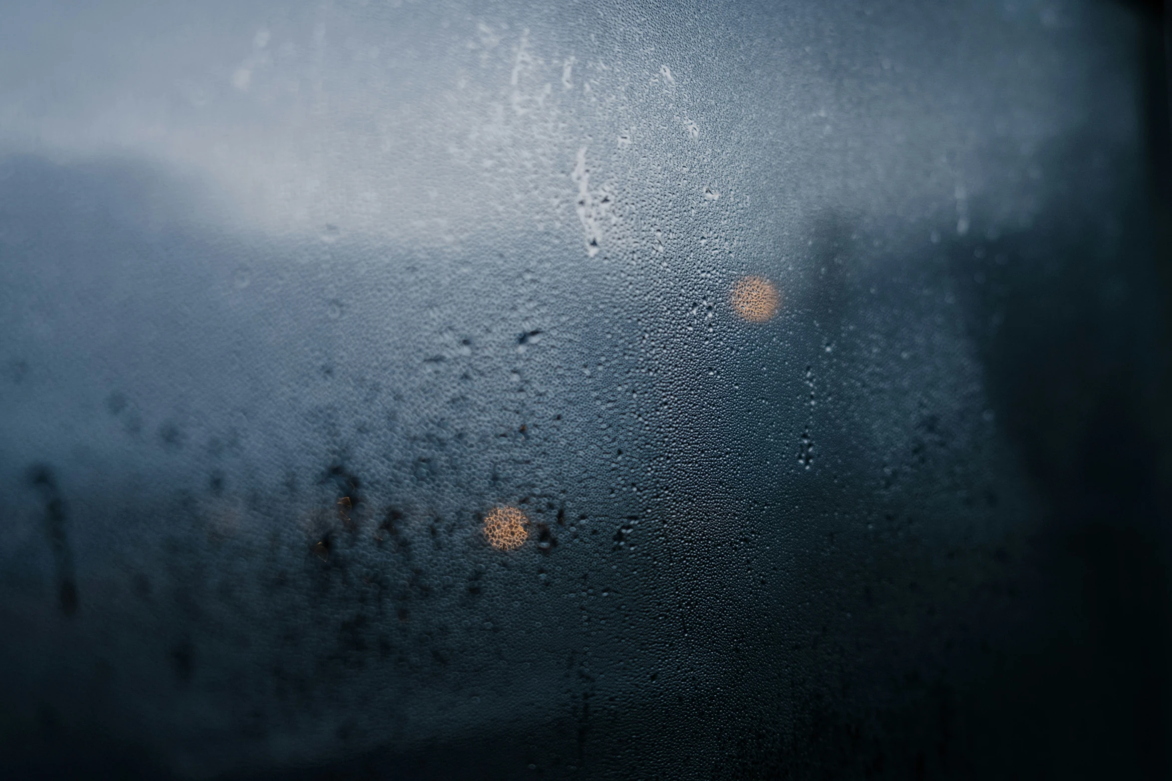 rain fell on the window and light shines through