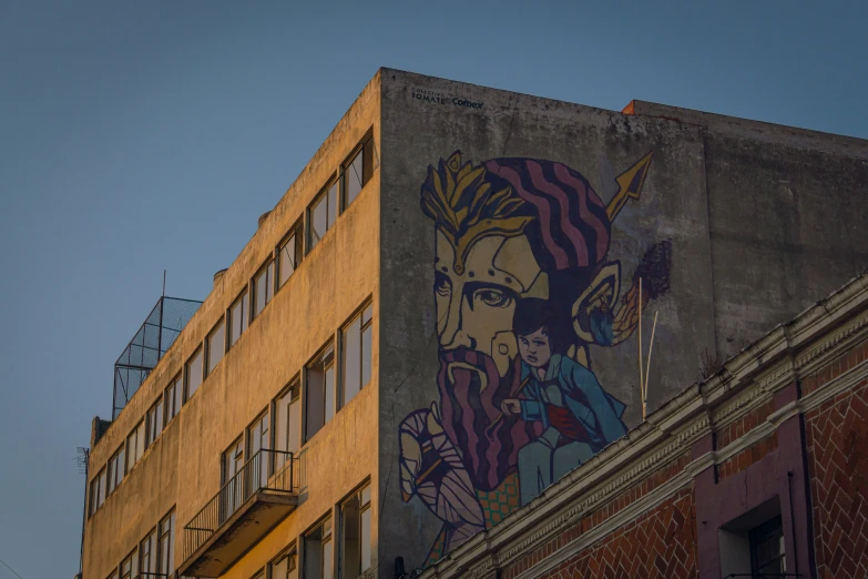 an old apartment building is painted with a mural of a woman