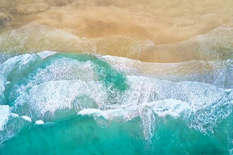 a wave is hitting on an ocean shore