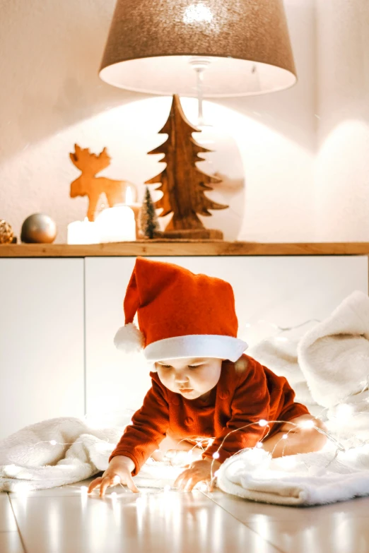 a young child in a santa hat is laying down