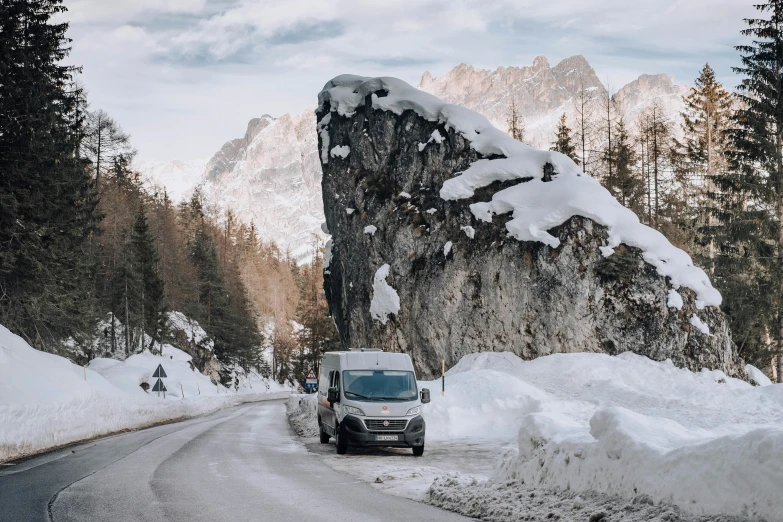 a truck is parked on a snowy road