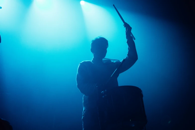 two people with guitars standing on a stage