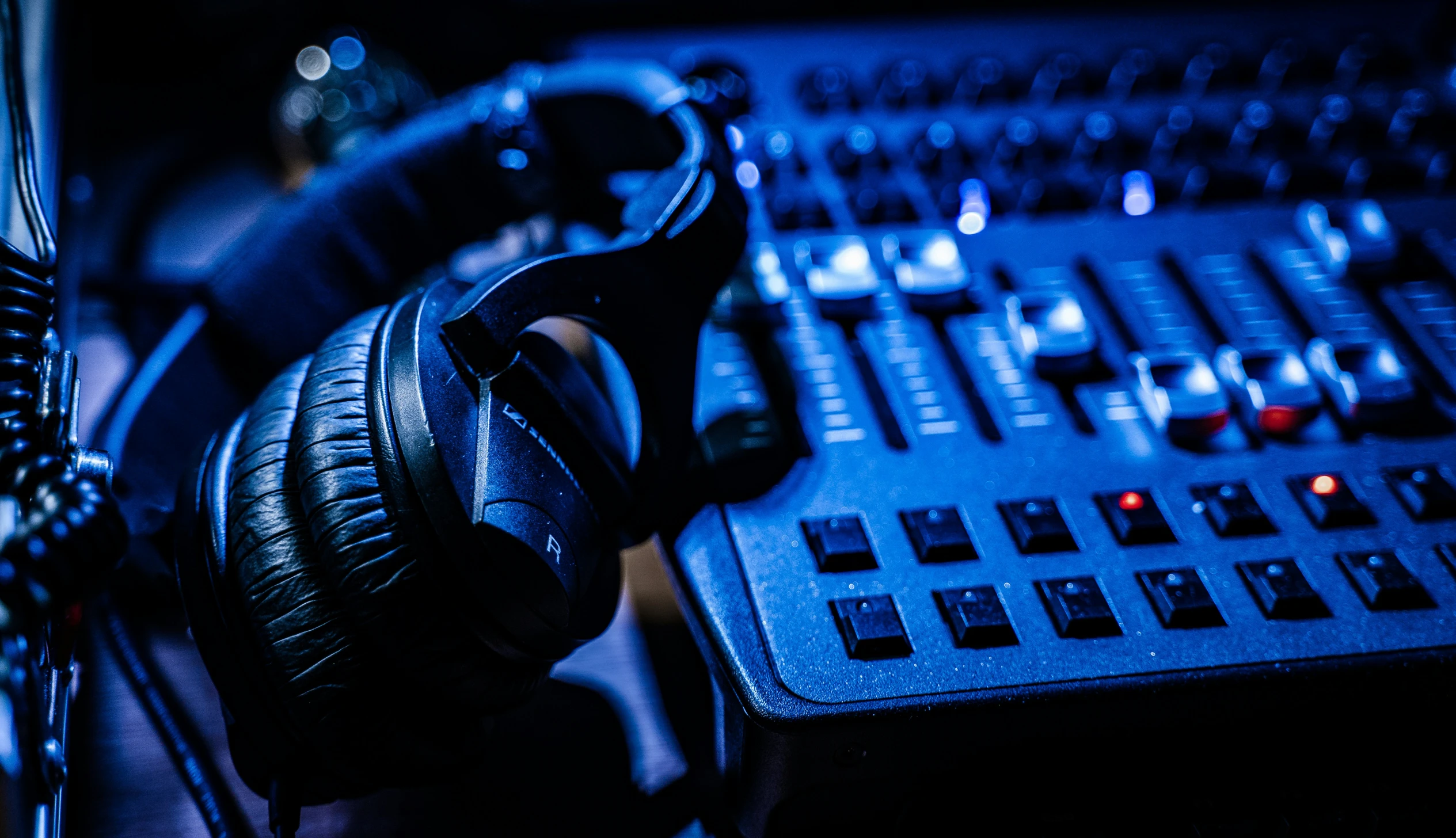 headphones and mixing board closeup with sound equipment