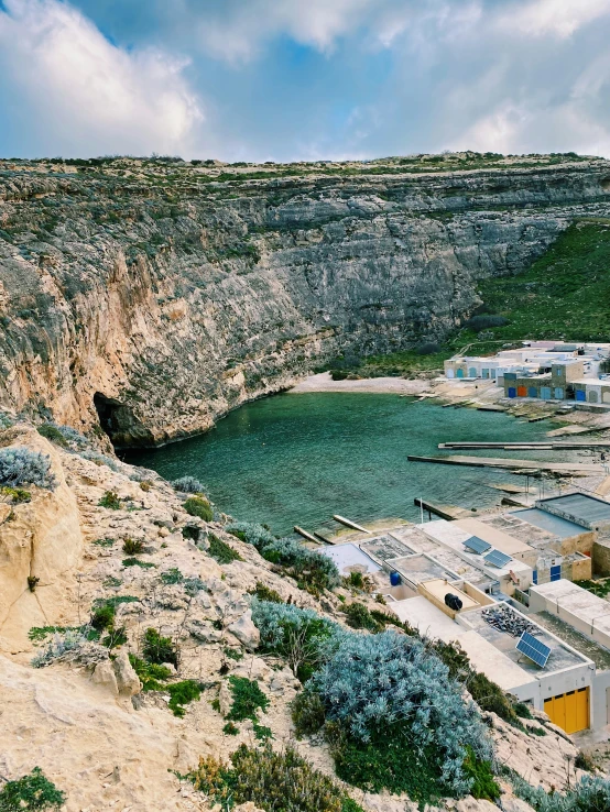 a scenic view looking down on the coast near some buildings