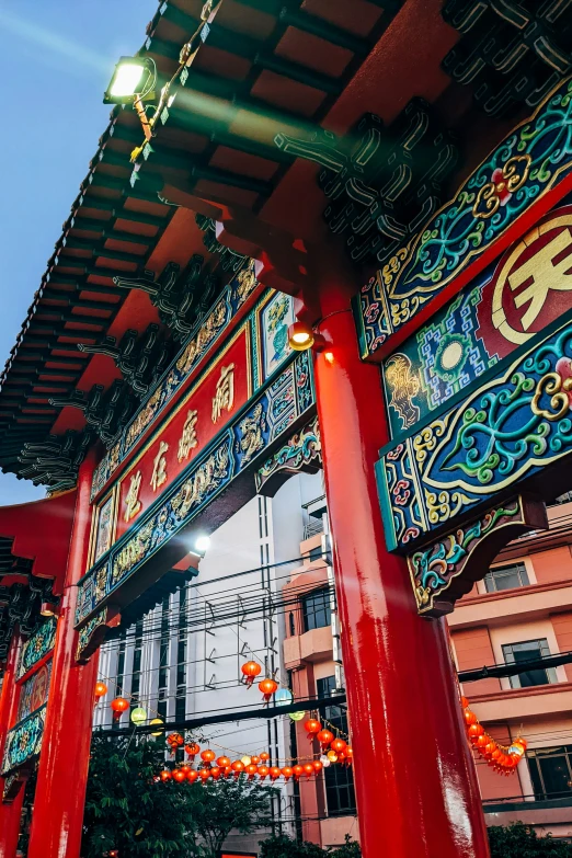 a tall building with red columns that are covered in decorative decorations