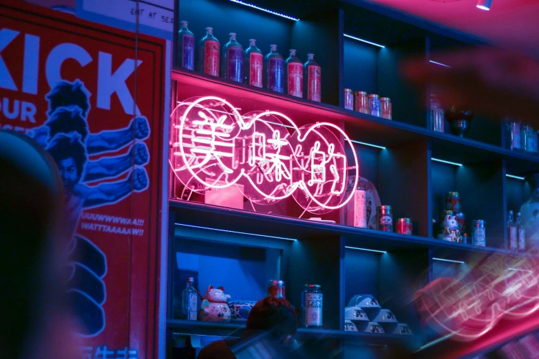a neon sign that is behind a bar