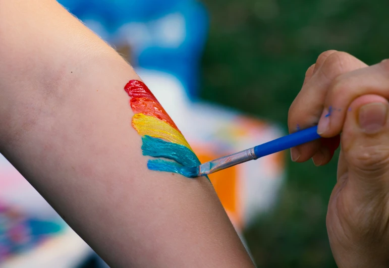 someone is holding a painting brush in their right hand