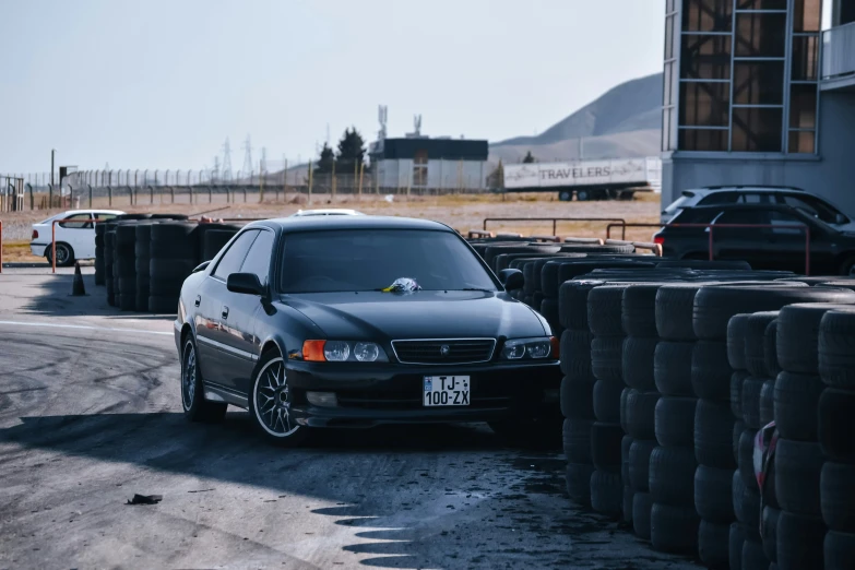 a black car parked on top of a parking lot