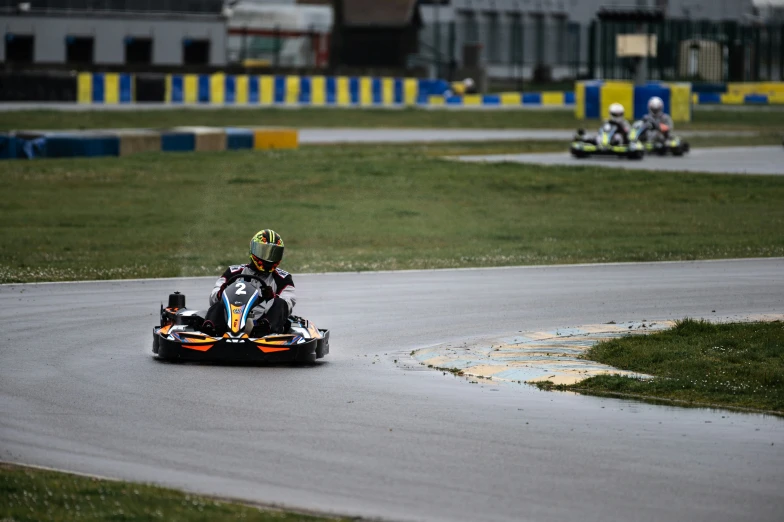 several people racing on motorcycles down a curved track