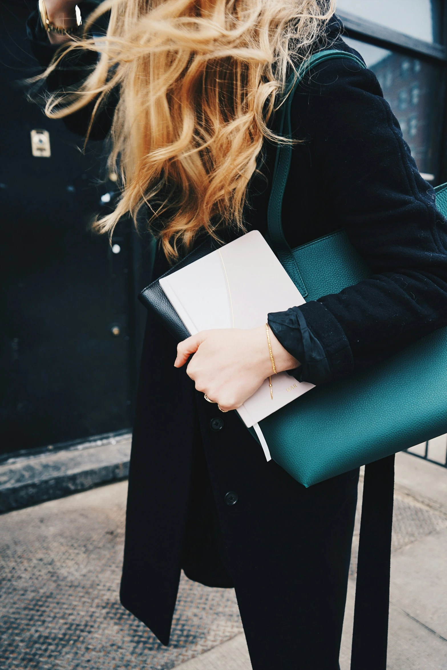 a girl holding a binder in her hand