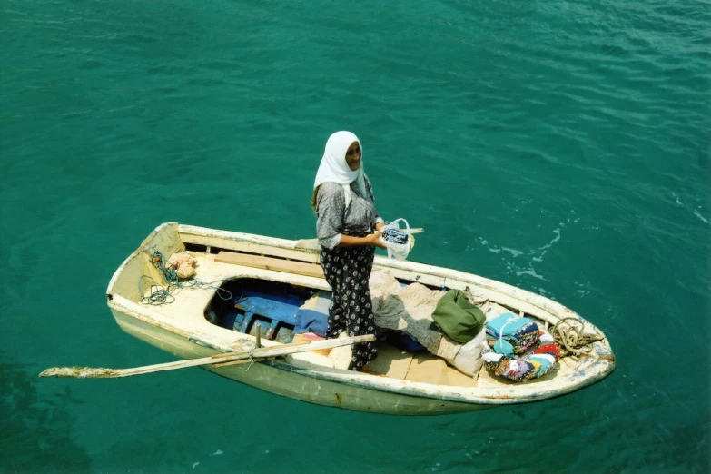 a woman stands on a boat floating in the water